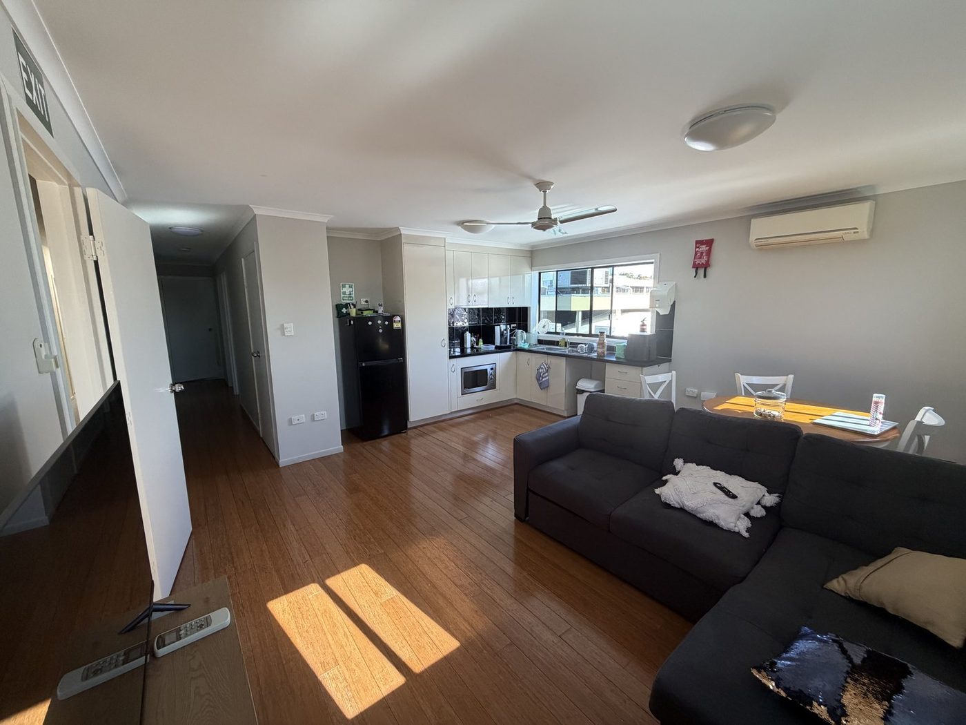 The emergency apartment kitchen and dining area, looking down the hallway toward the bedrooms