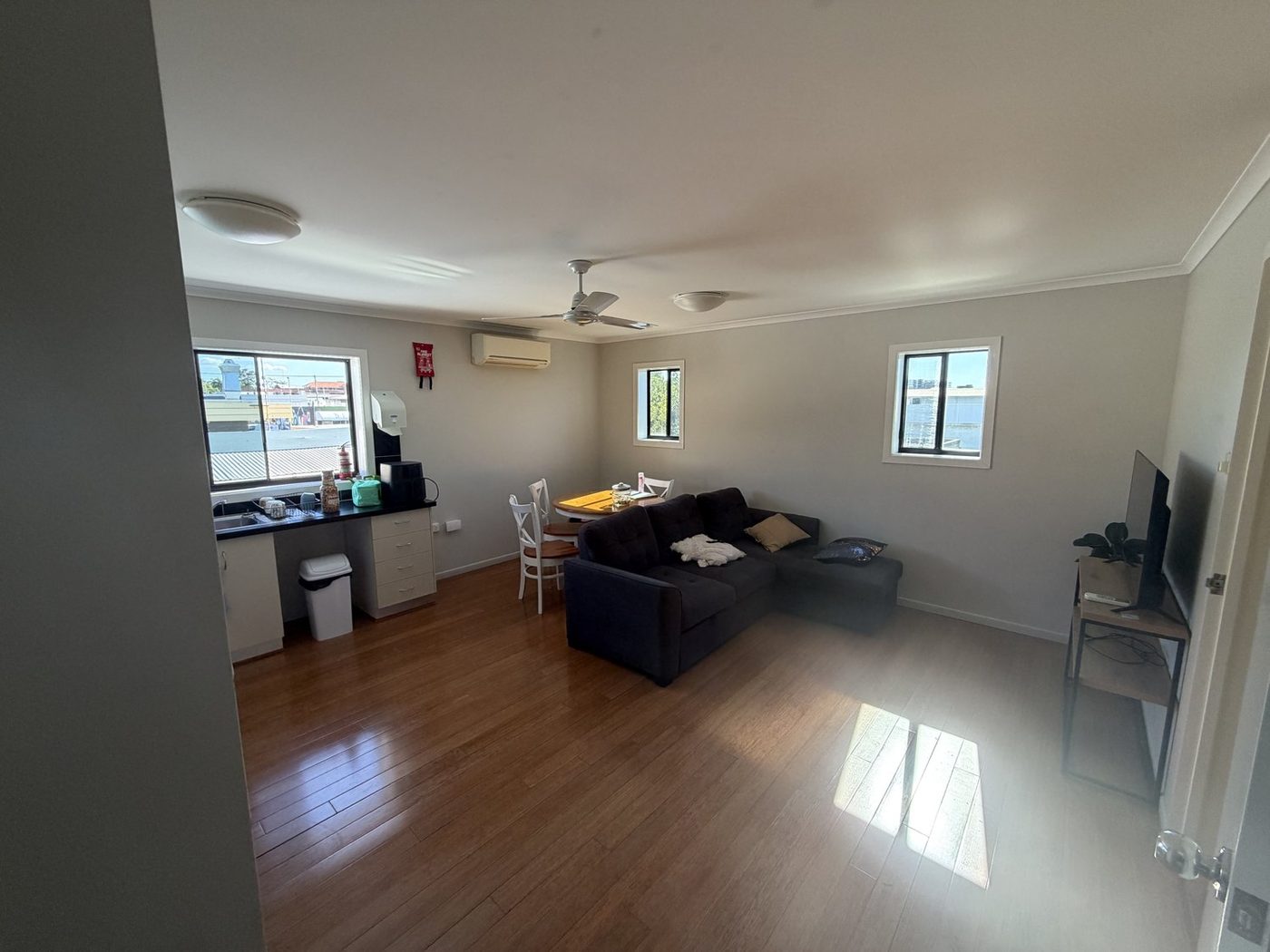 The emergency apartment living area, with a lounge, dining table and kitchenette