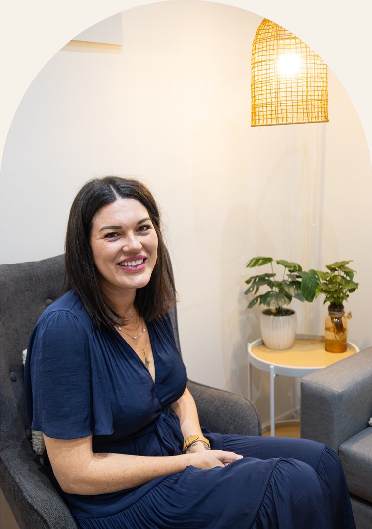 Stacey Mossman, therapeutic counsellor at Brave Minds, sitting in an armchair in the counselling room